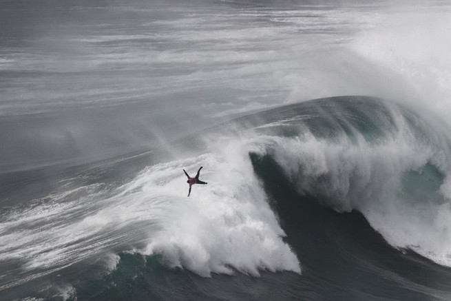 Eric Rebiere falls while riding a wave in Praia do Norte, Nazare, Portugal