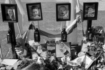 A memorial with photos of Shiri, Ariel, and Kfir Bibas and Oded Lifshitz in Tel Aviv