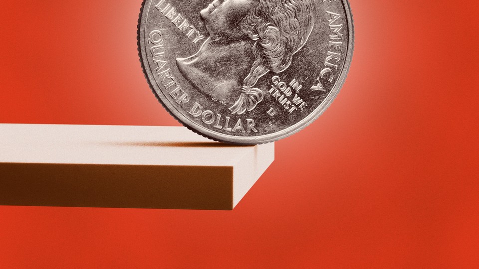 A U.S. quarter at the edge of a plank