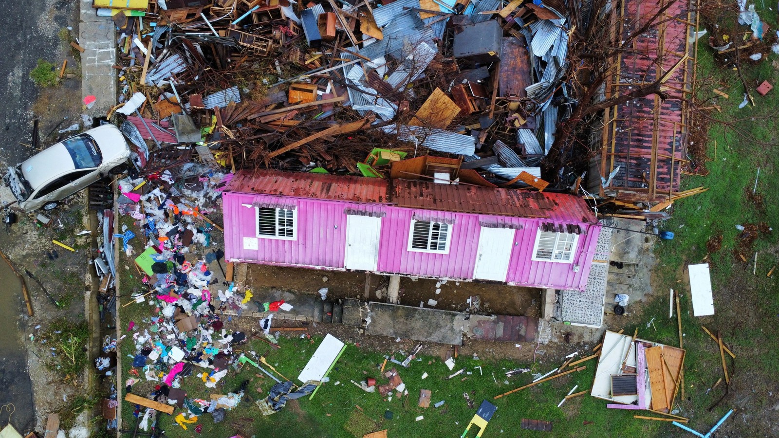 A drone view of severe damage to houses caused by a hurricane