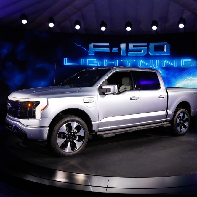 A Ford F-150 Lightning is displayed at an auto-show.