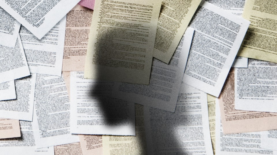 A shadow of a woman against a wall of legal papers