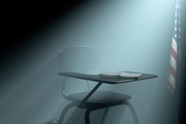 Illustration of an empty school desk in a dark room with an american flag behind it and light shining from above