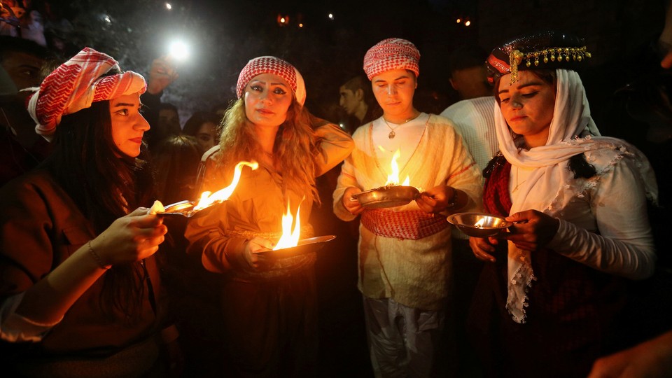 Yezidis light candles and paraffin torches during a ceremony to celebrate the New Year in Dohuk province, Iraq, in 2017.