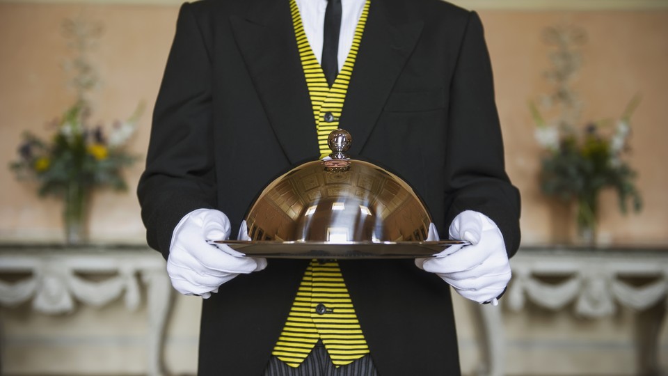 Butler holding a serving tray