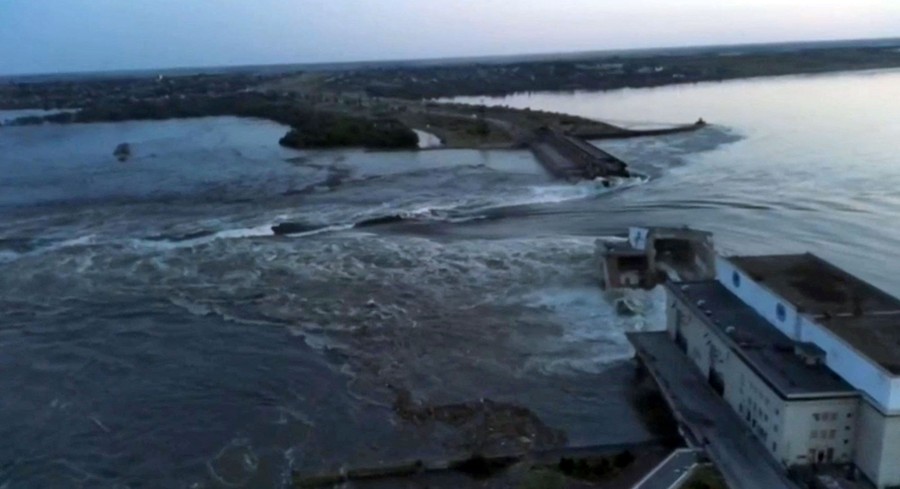 Huge volumes of water rush through a breached dam.