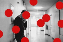 Photo of a person in a hospital hallway, overlaid with large red dots