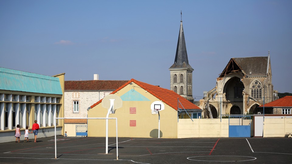 A playground is in the foreground. A church steeple is behind it.