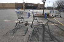 Two shopping carts in a Walmart parking lot 