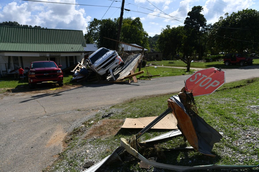 A view of the flood damage, including a bent stop sign wrapped in debris