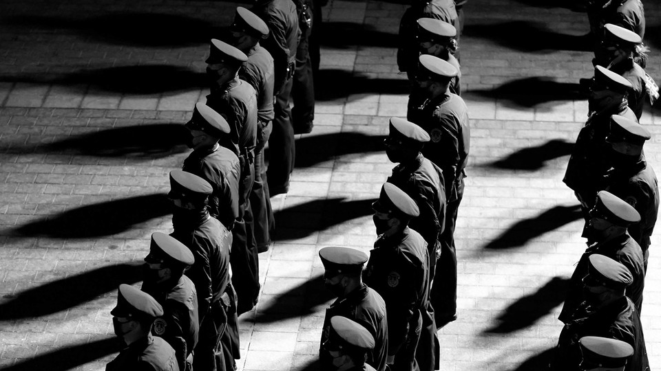 Police officers stand in rows.