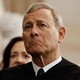 Chief Justice John Roberts frowns slightly while he wears his robes