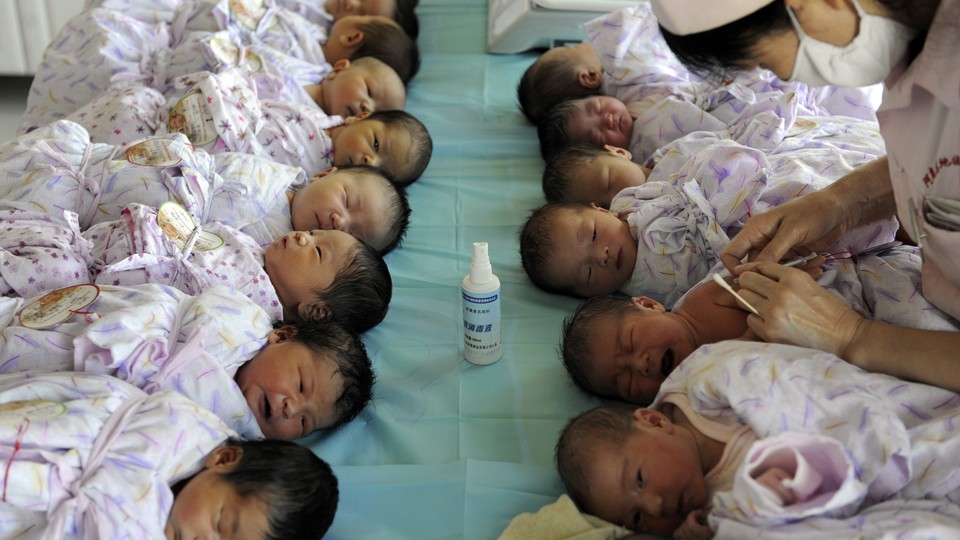 Two rows of babies waiting to receive vaccines 