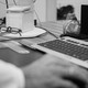 Black-and-white photo of someone at a desk