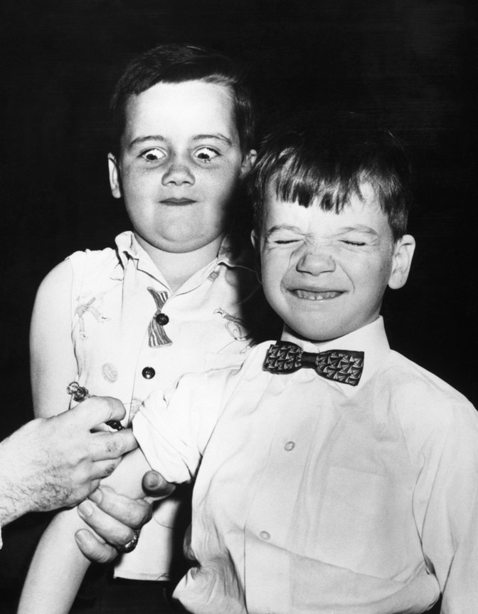 One boy received a vaccine while another next in line looks on