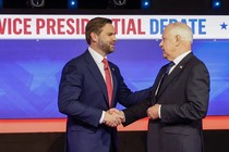 J. D. Vance and Tim Walz shake hands at the debate