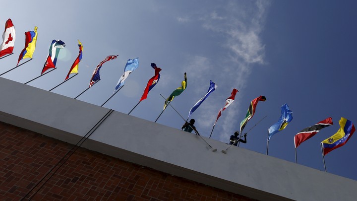 A photo taken from below a row of flags from around the world