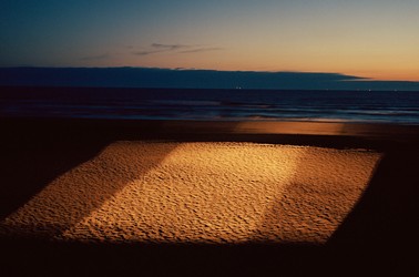 A square of light over sand on the sea