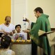 Pastor Gottfried Martens lights a candle during a service to baptize people from Iran, in the Trinity Church in Berlin, Aug. 30, 2015.