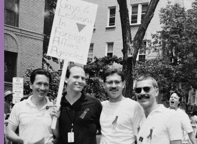 men hold a protest sign. for gays and lesbians in foreign service