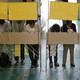 Voters fill out ballots for Japan's upper house election at a polling station in Tokyo on July 11, 2010.