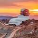 a photo of the Vera Rubin Observatory with a colorful sky