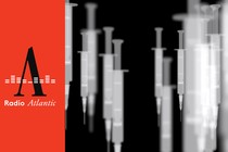 A handful of vaccine syringes photographed in black and white appear to be floating