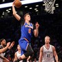 New York Knicks power forward Kristaps Porzingis dunks against the Brooklyn Nets 