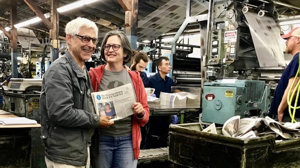 Editor Ed Miller and publisher Teresa Parker with Vol. 1 No. 1 of The Provincetown Independent as it comes off the press on Sept. 6