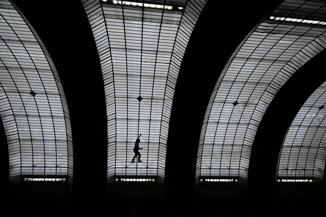 French tightrope walker Nathan Paulin walks on a wire during a performance of "Les Traceurs Theatre de Chaillot au Musee d'Orsay" by Rachid Ouramdane, as part of the European Heritage Days and the Cultural Olympiad in Paris, on September 16, 2023.