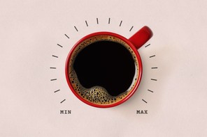 A mug of coffee surrounded by a min–max dial