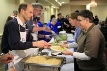 Maine's former governor John Baldacci, left, serves spaghetti at a fundraising event to benefit the Preble Street Resource Center, an agency that helps the homeless, in 2010.