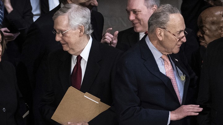 Mitch McConnell and Chuck Schumer stand back-to-back.