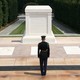 A soldier stands in front of the Tomb of the Unknown Soldier