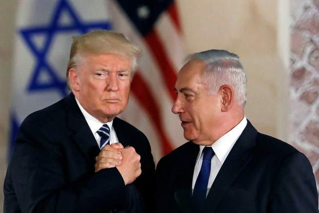 Donald Trump grips Benjamin Netanyahu's hand