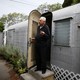 A man standing in the doorway of his mobile home