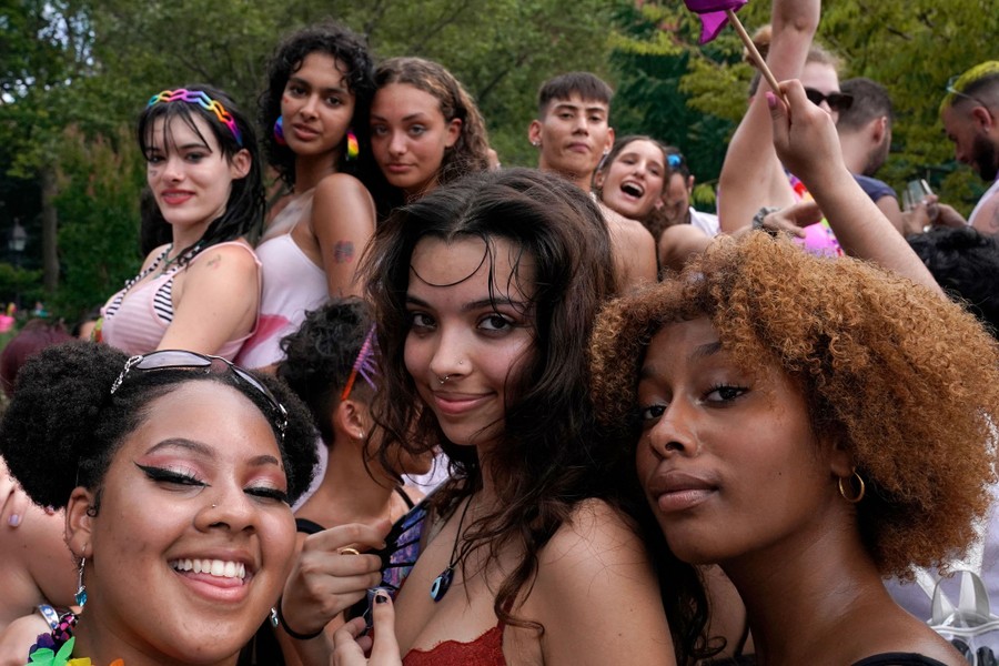 About a dozen people are sen celebrating together in a park.