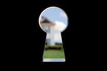 illustration of large keyhole in focus through which is a blurry house with blue sky and green lawn in distance