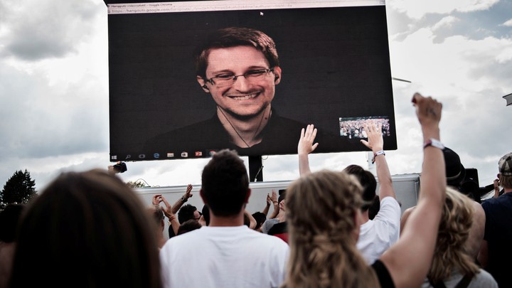 American whistleblower Edward Snowden is seen on a screen as he delivers a speech during the Roskilde Festival in Roskilde, Denmark, on June 28 2016.