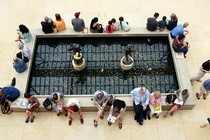 People sit around a fountain at the Metropolitan Museum of Art