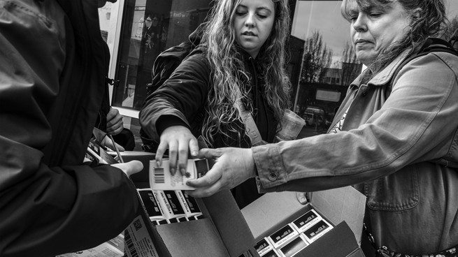 Workers from the organization Central City Concern hand out Narcan in Portland, Oregon, on April 5.