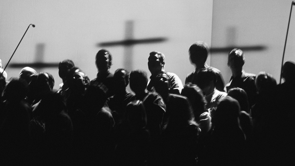 A black-and-white photo of Christian worshippers