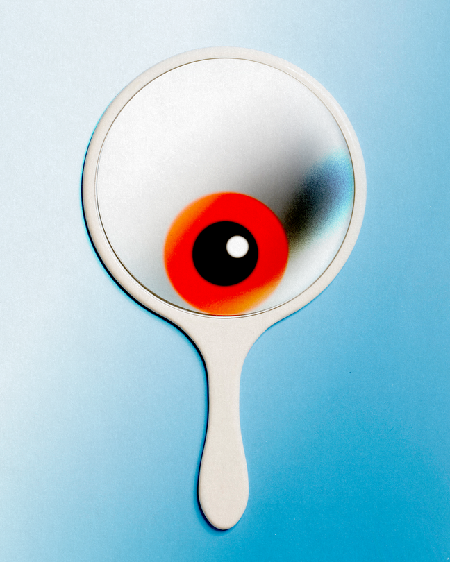 A photo-illustration of a handheld mirror with a red eyeball reflected inside