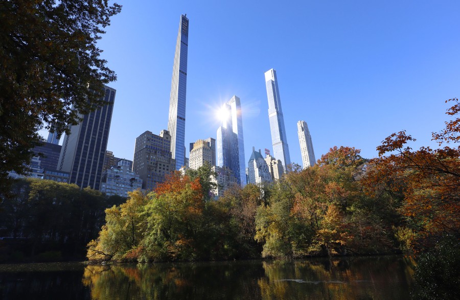 A view of New York City skyscrapers, seen from a pond in a park.
