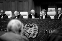 A black-and-white photograph of the judicial bench in the International Court of Justice