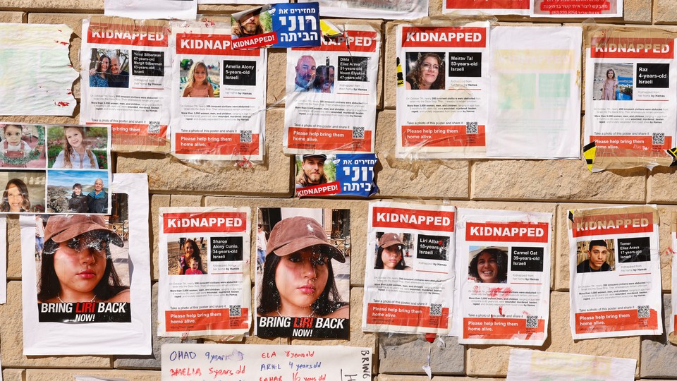A photo of a pinboard where people have posted details of relatives taken hostage by Hamas.