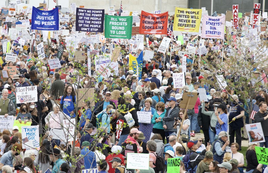 An overview of many protesters carrying signs, including one that reads "This is what democracy looks like."