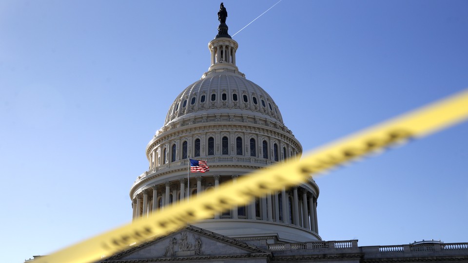 The Capitol dome framed by yellow police tape