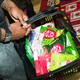 A person carries a grocery basket of KitKats.