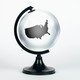 A transparent globe with an outline of the US contained inside it